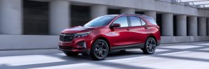 The 2022 Chevrolet Equinox driving in front of pillars.